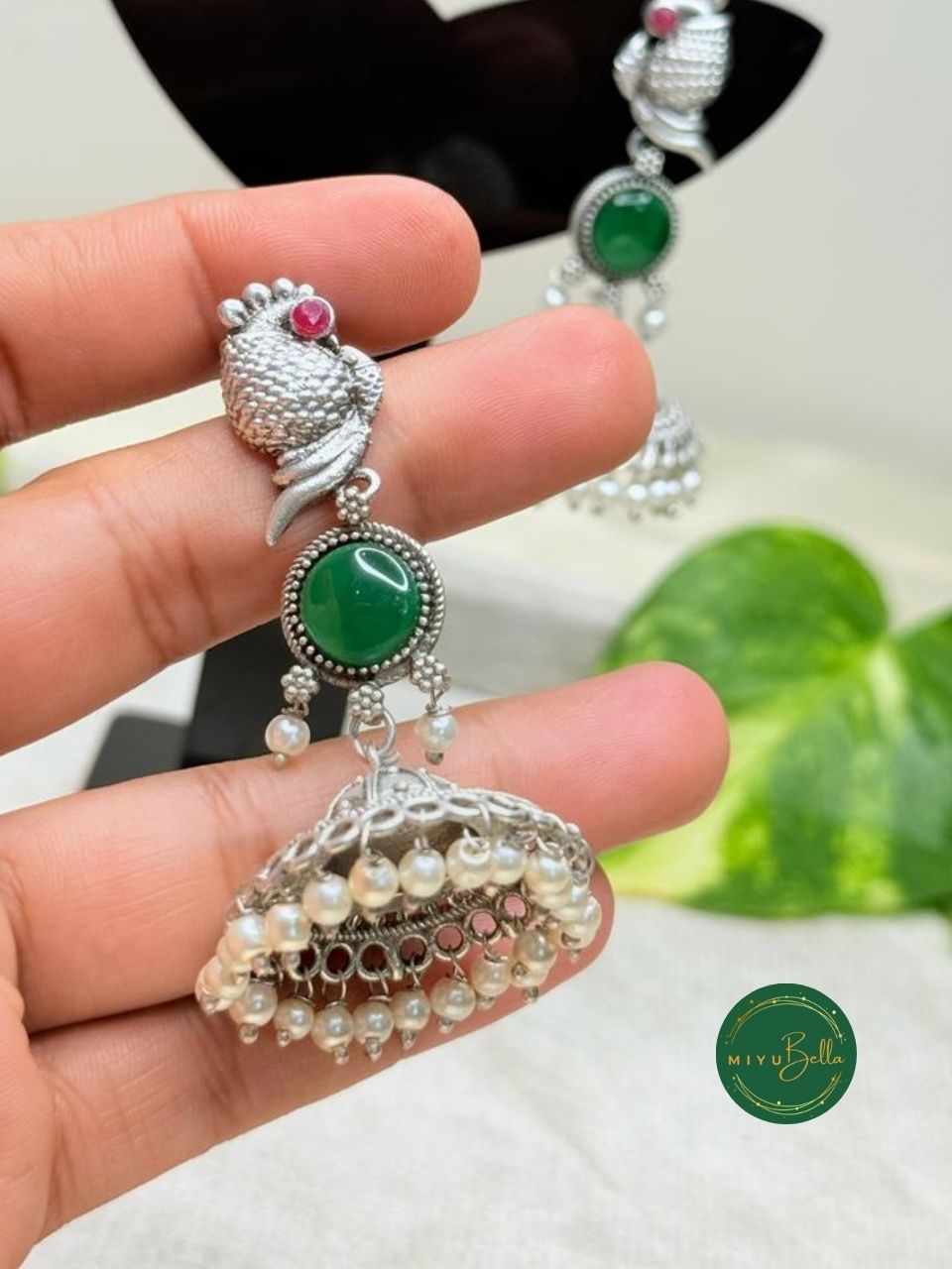 Kanak – Silver Finish Jhumkas with Pearls and Green Stone Accents